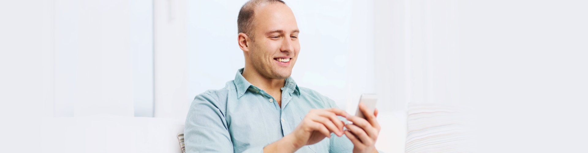 man is happy while using his phone